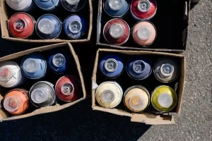 Picture of paint cans in boxes for the blog how to dispose of household items