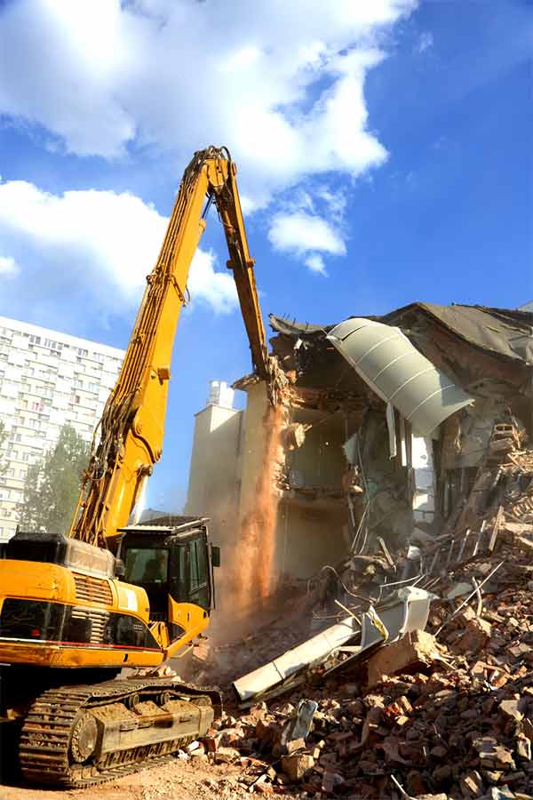 Picture of a construction and demolition crane wrecking a building in Durham, NC.