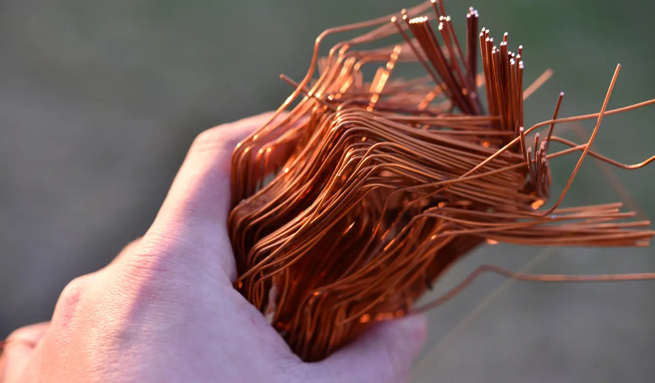 Picture of a person holding copper wires for the article about copper recycling near me.