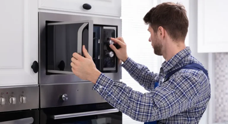 Person testing an old microwave for the article about how to dispose of a microwave in North Carolina.